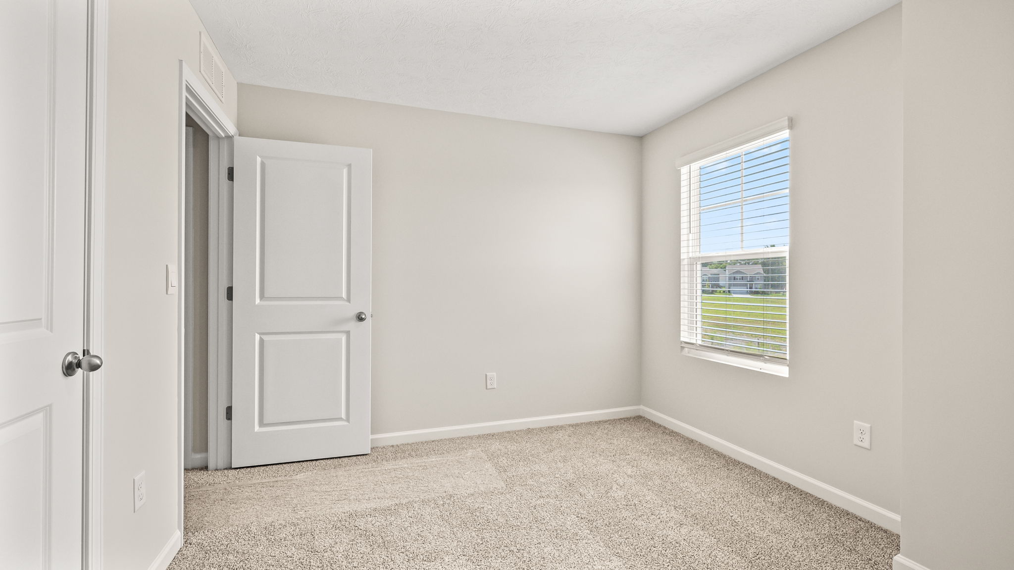 Carpeted bedroom with window