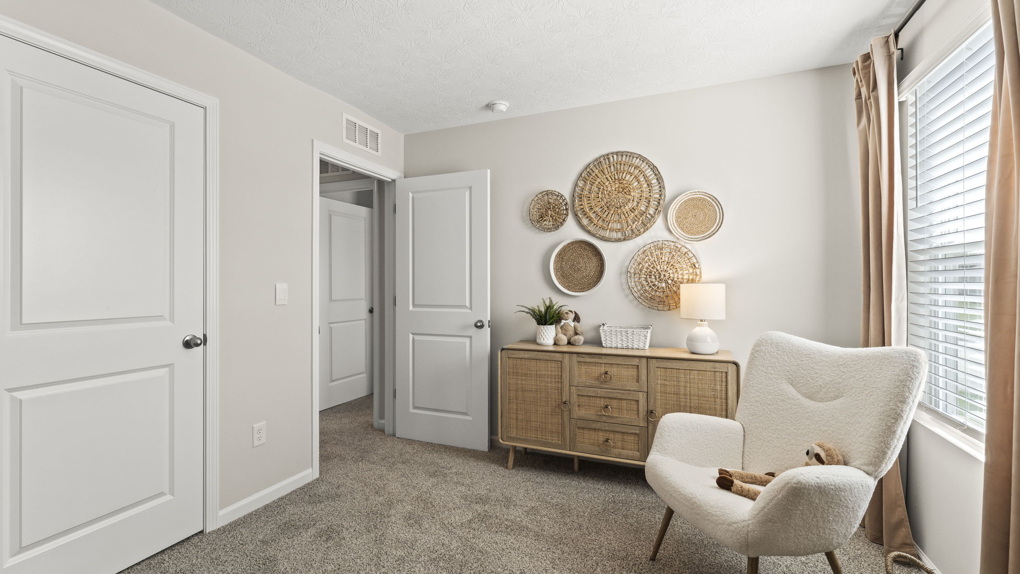 Bedroom with view of cabinets, art, and chair