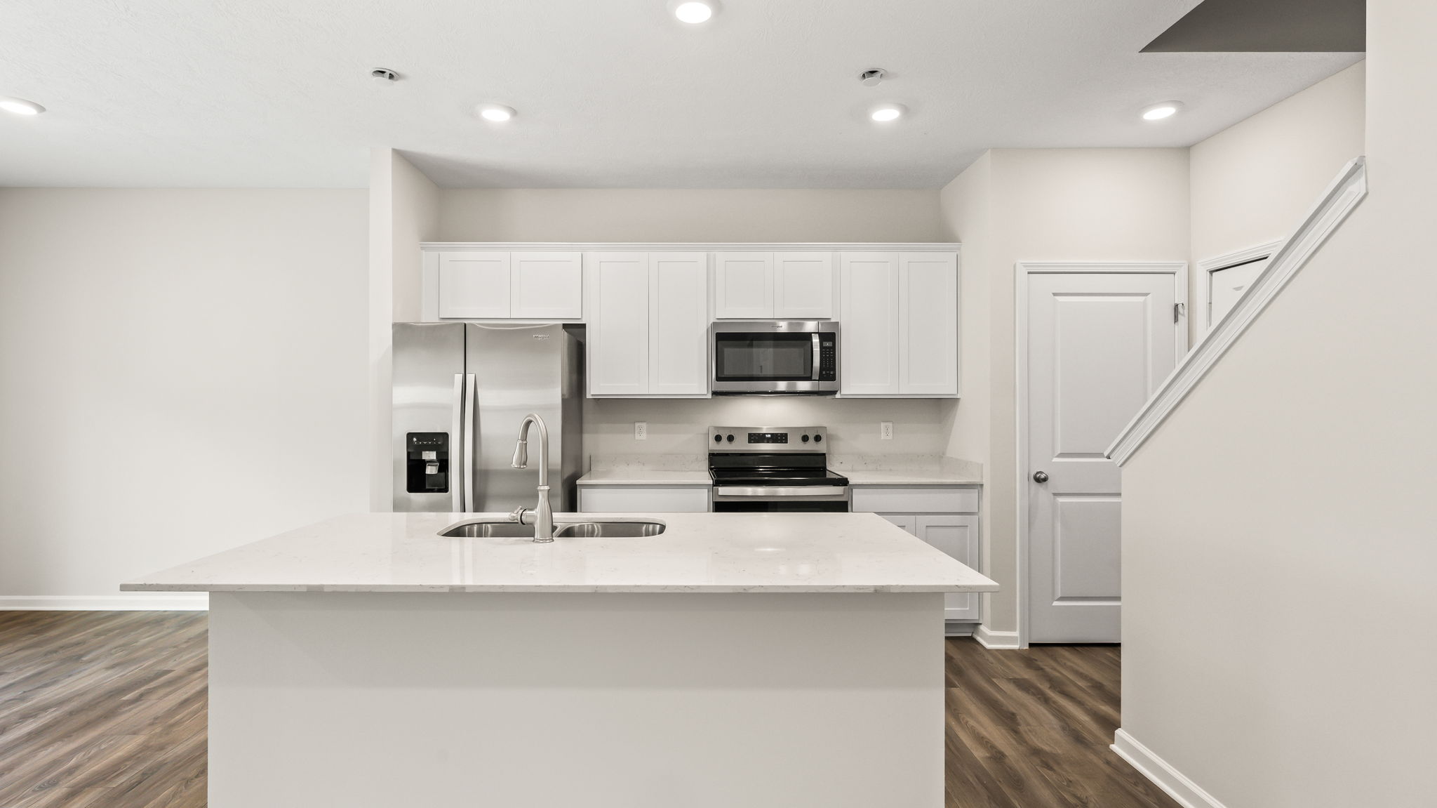 Full kitchen with white cabinetry