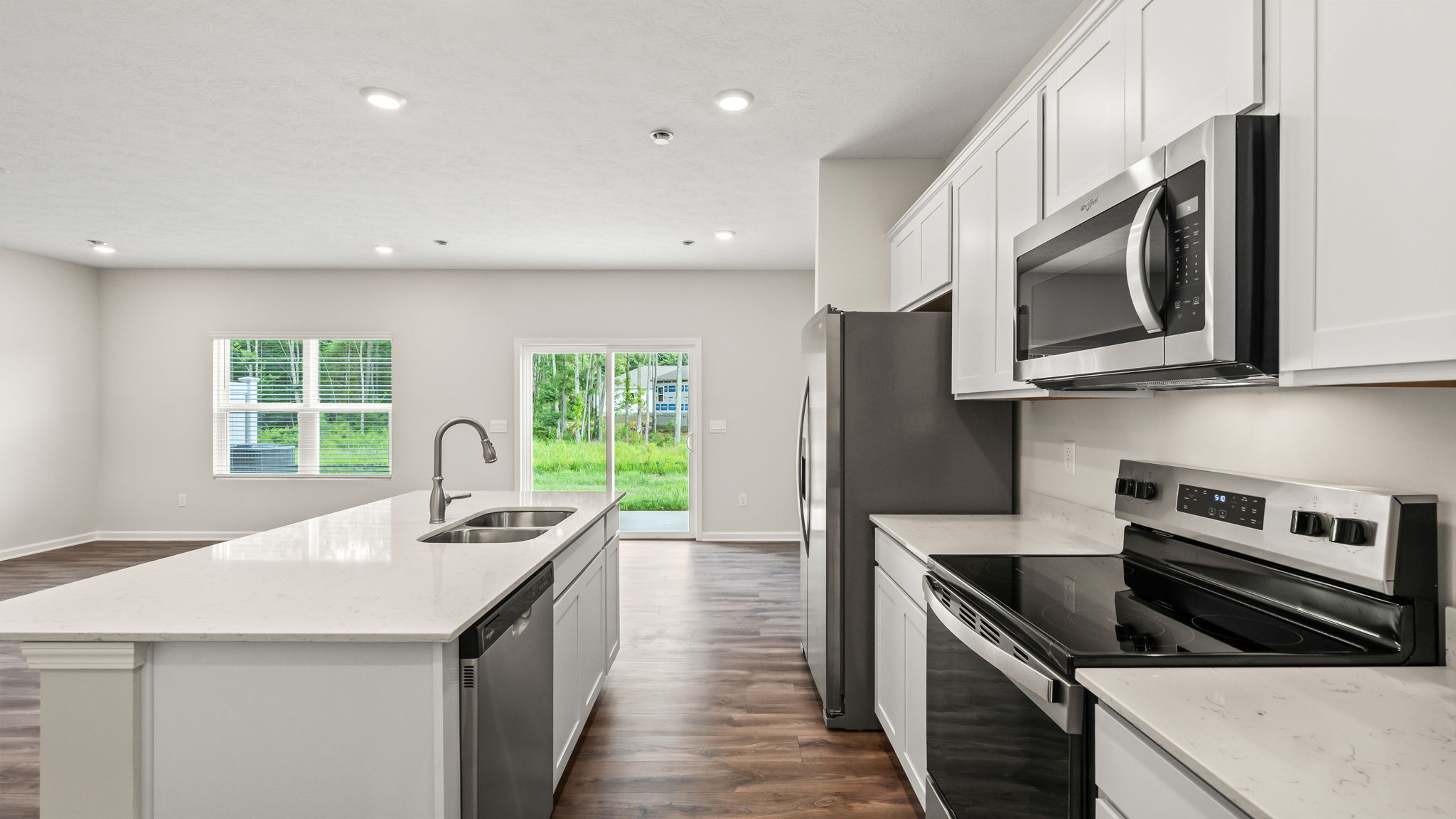 Side view of kitchen with island on the left and oven range on the right