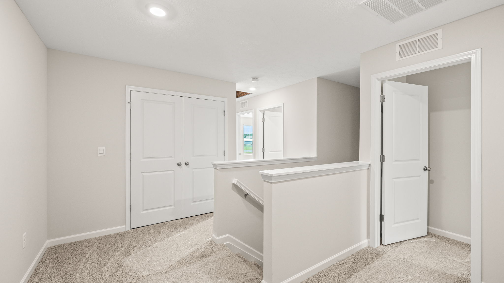 Upstairs landing with view of 2nd level room