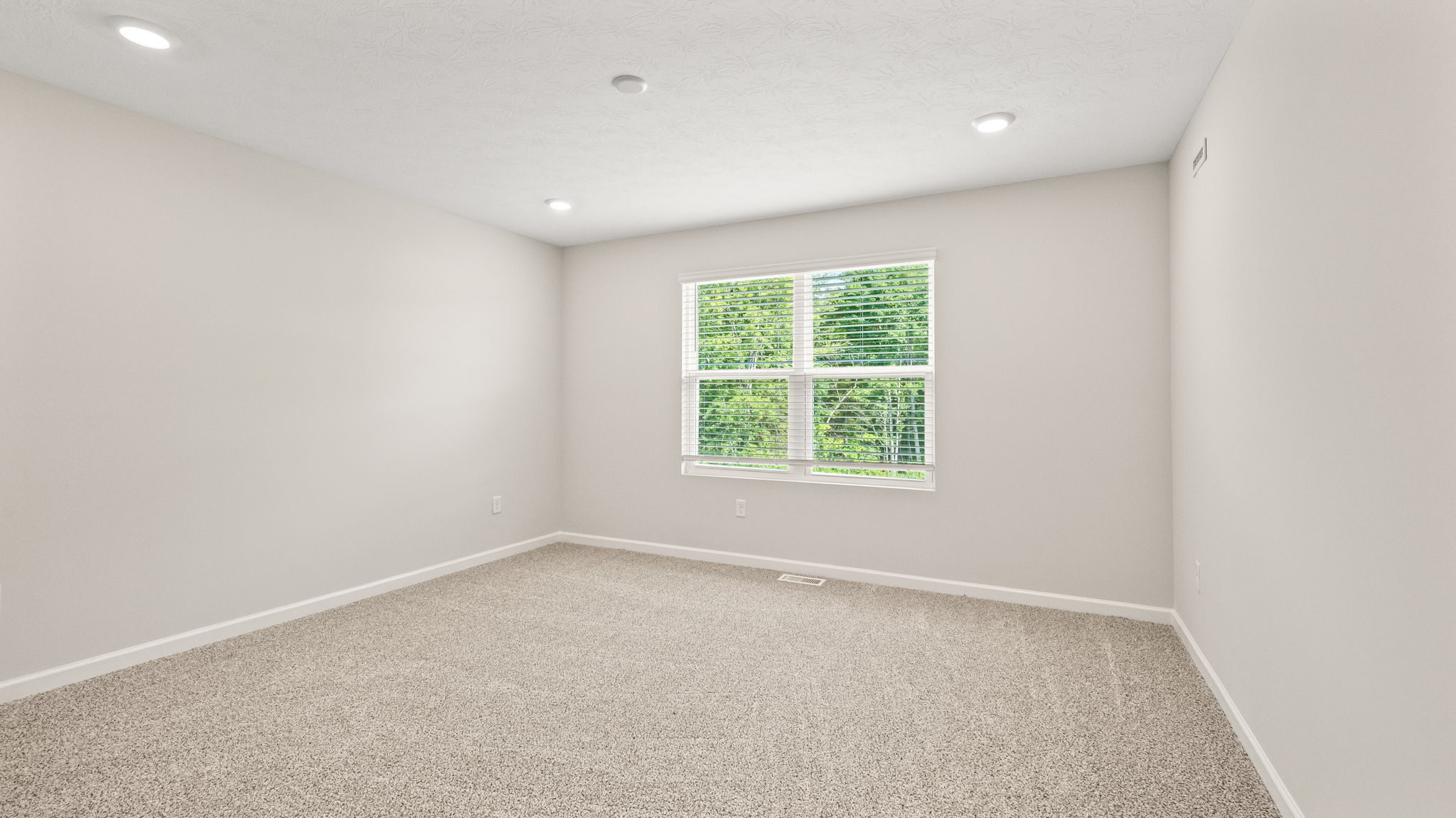 Carpeted bedroom with window