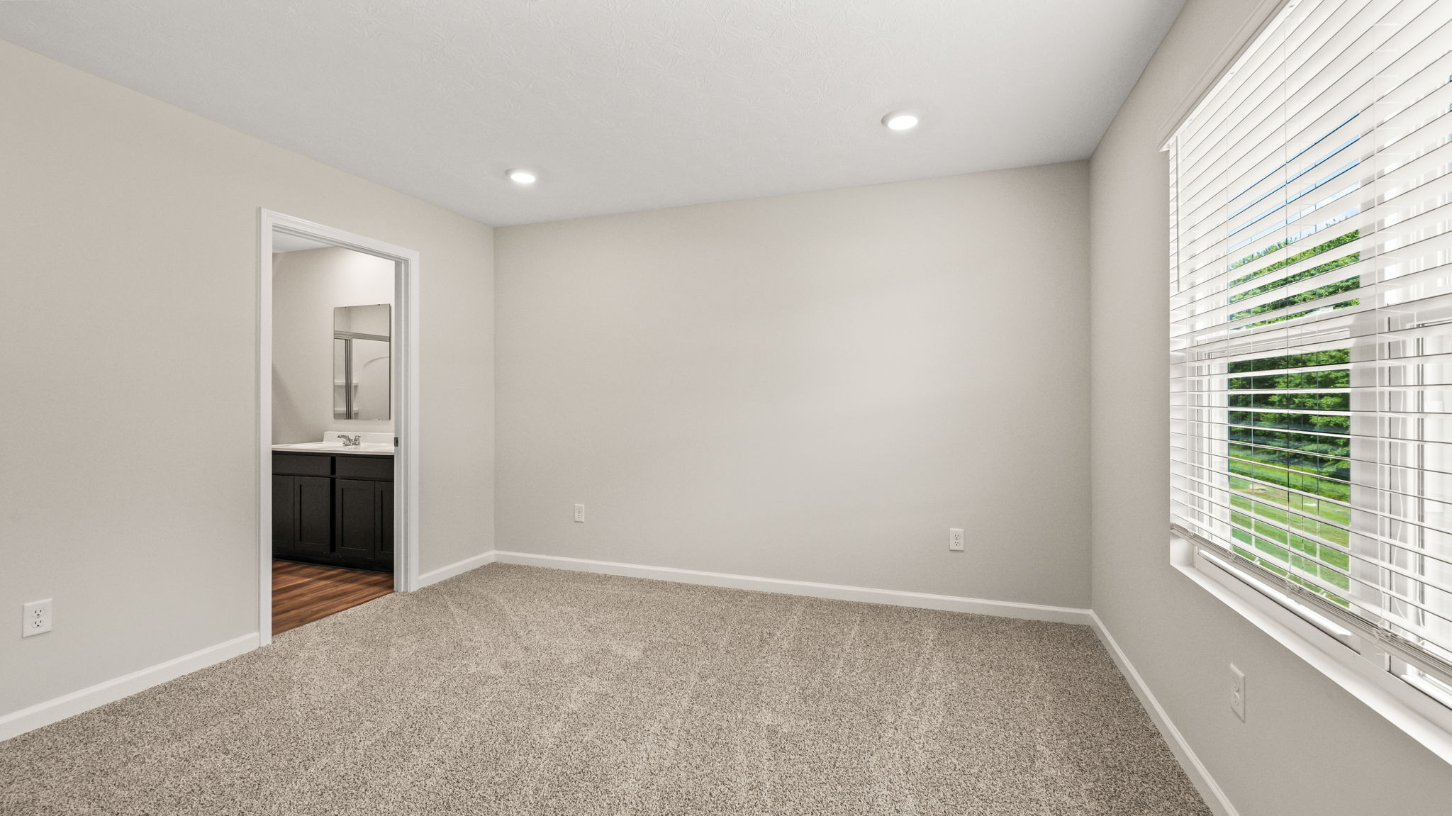 Carpeted primary bedroom