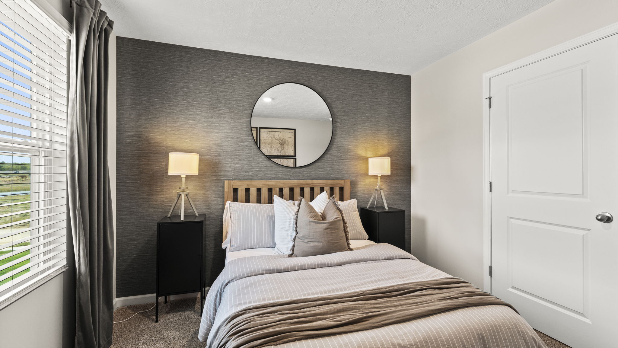 Bedroom with dark backdrop contrasting the bed