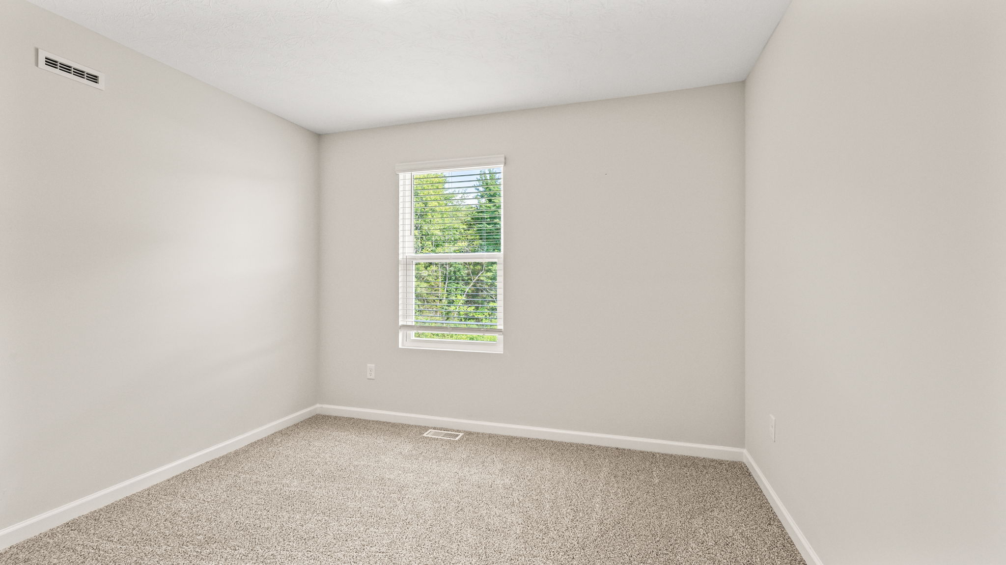 Carpeted bedroom with window