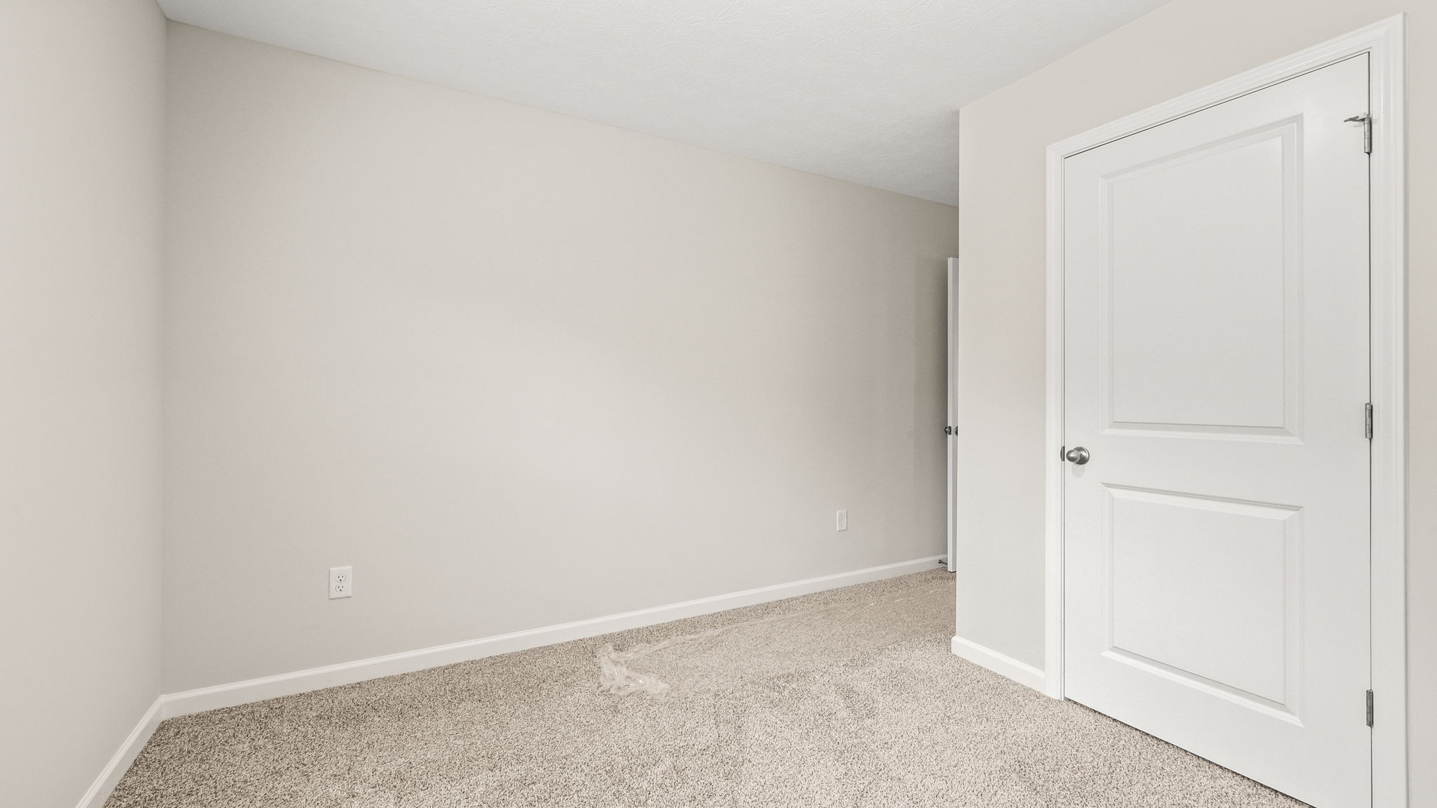Carpeted bedroom with closet