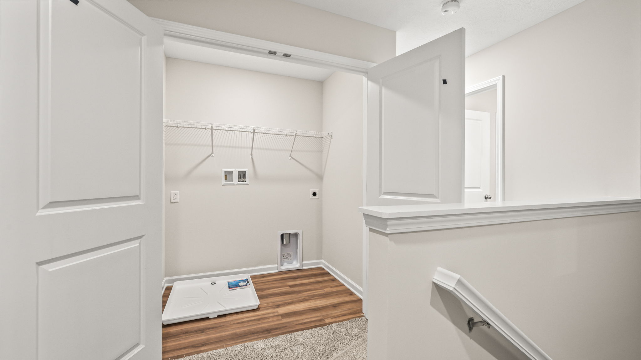 Laundry area with washer/dryer inlets and wire rack shelving