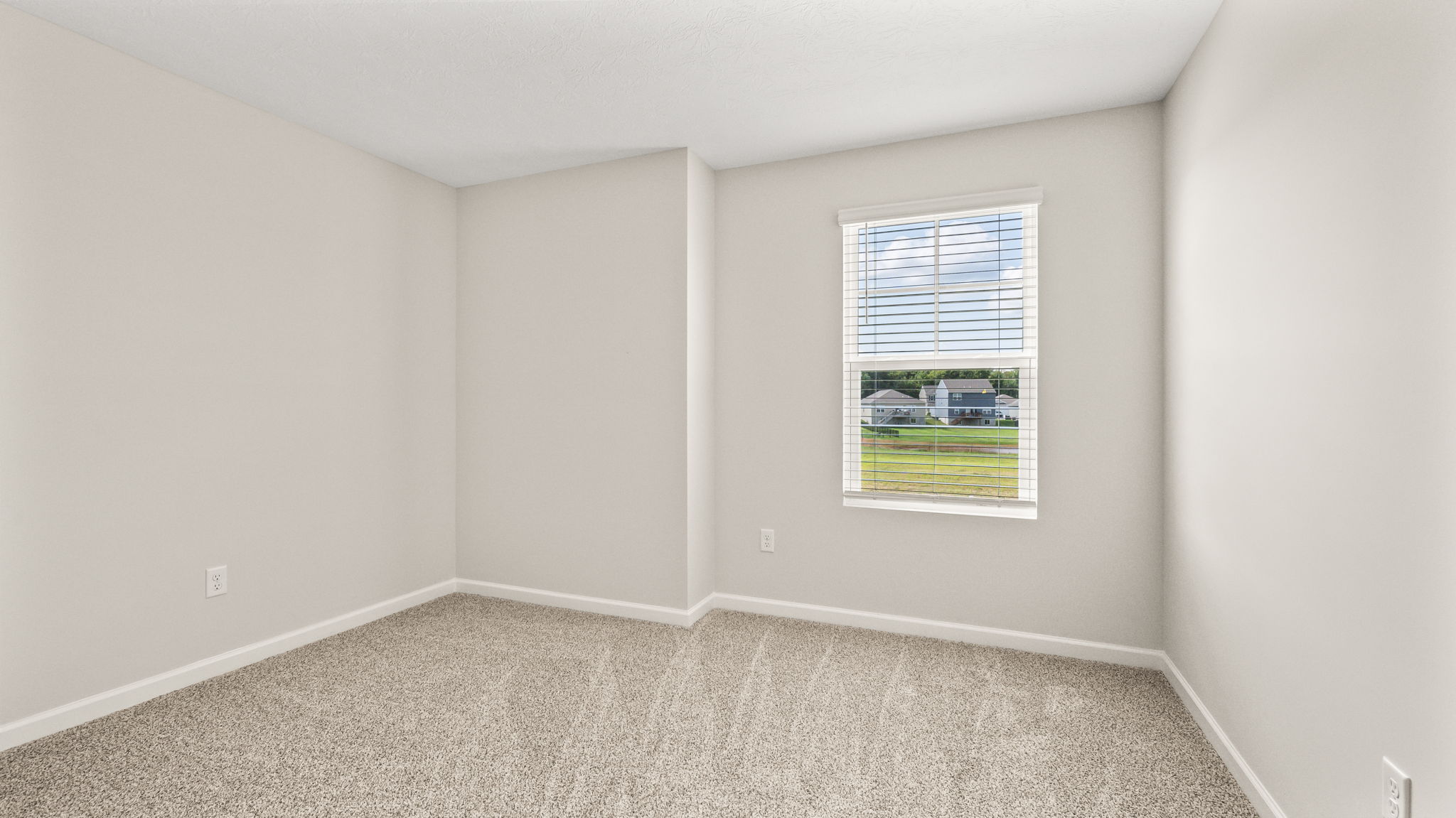 Carpeted bedroom with window