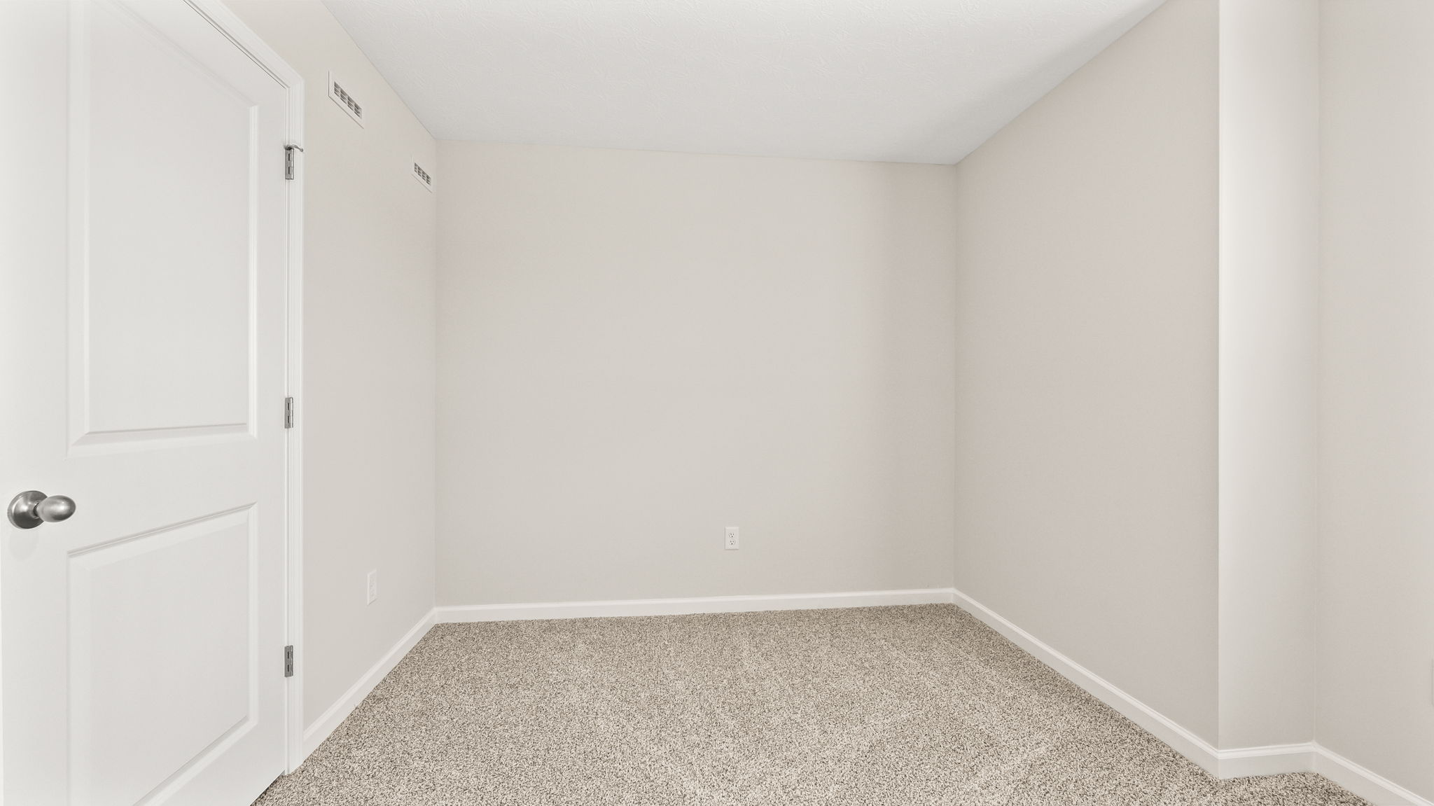 Carpeted bedroom with closet door