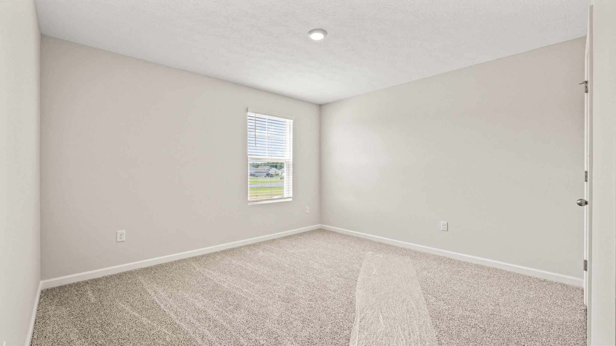 Carpeted bedroom with window