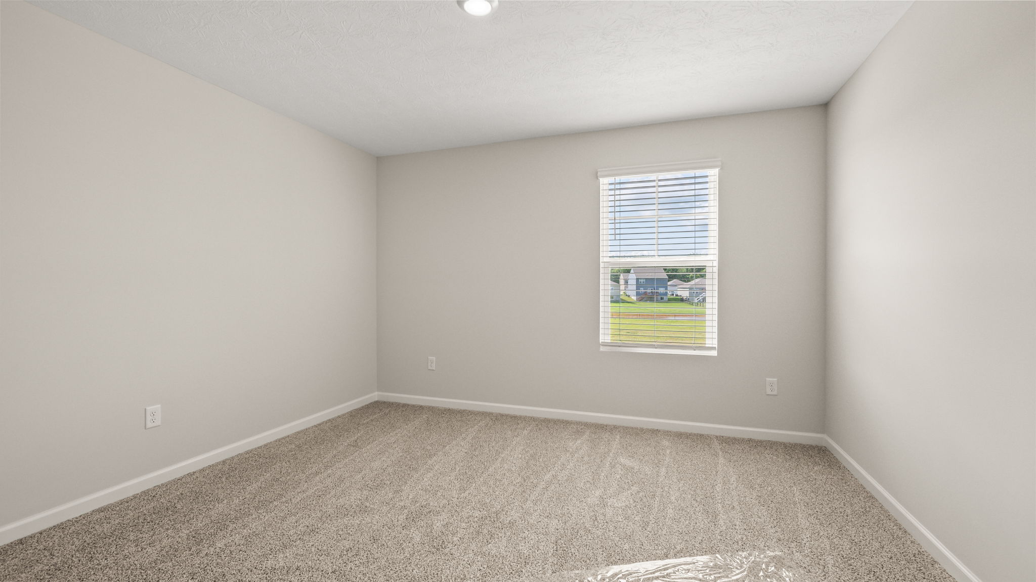 Carpeted bedroom with window