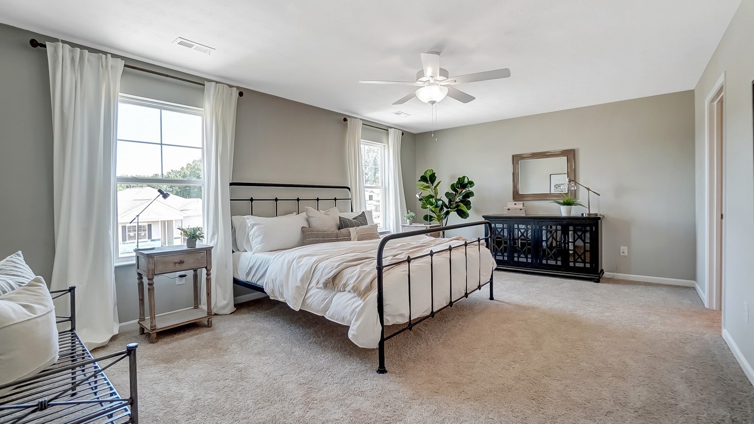 Primary Bedroom with large bed and elegant decorations.