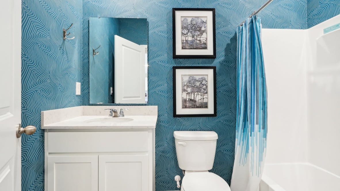 Bathroom with sink, mirror, toilet, and tub