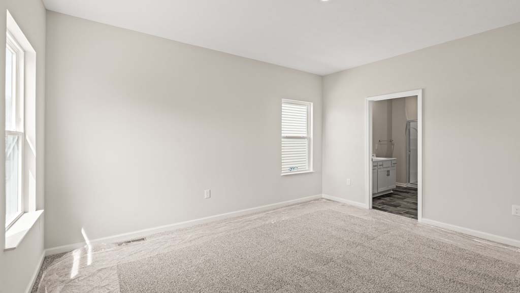 Primary bedroom looking into primary bathroom