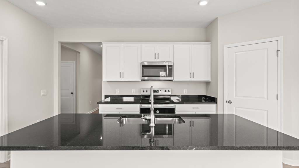 Kitchen sink embedded in black countertop