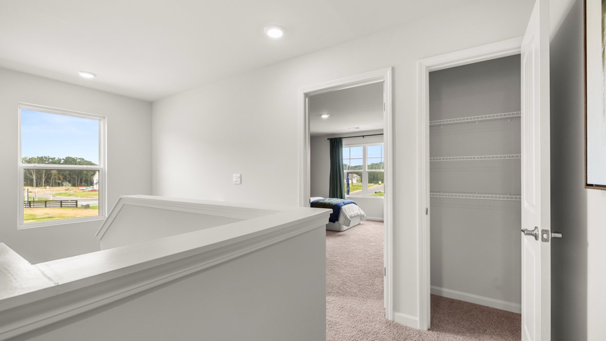 Upstairs landing with view of bedroom and closet