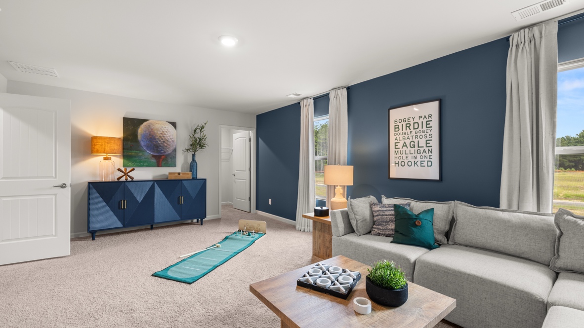 Full game room with tick tack toe board on coffee table, couch, and blue walls