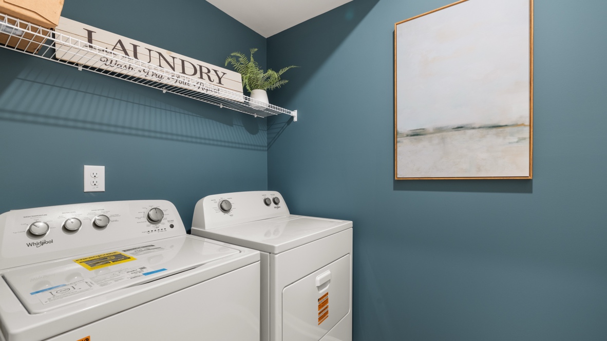 Closeup of laundry room area with wire rack shelving and blue walls.