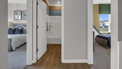 hallway off the left of the foyer with two bedrooms and a shared bathroom.