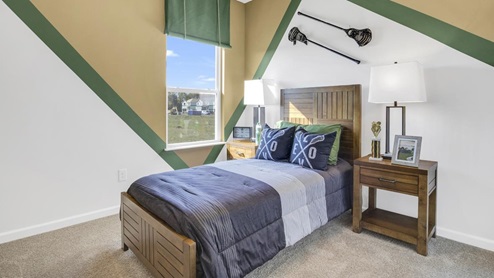 bedroom with lacrosse theme showing wood bed frame and dual bedside tables.