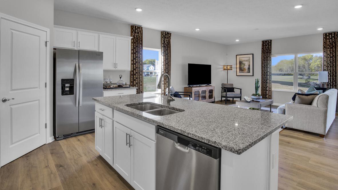 kitchen island with stainless steel appliances and open concept great room.