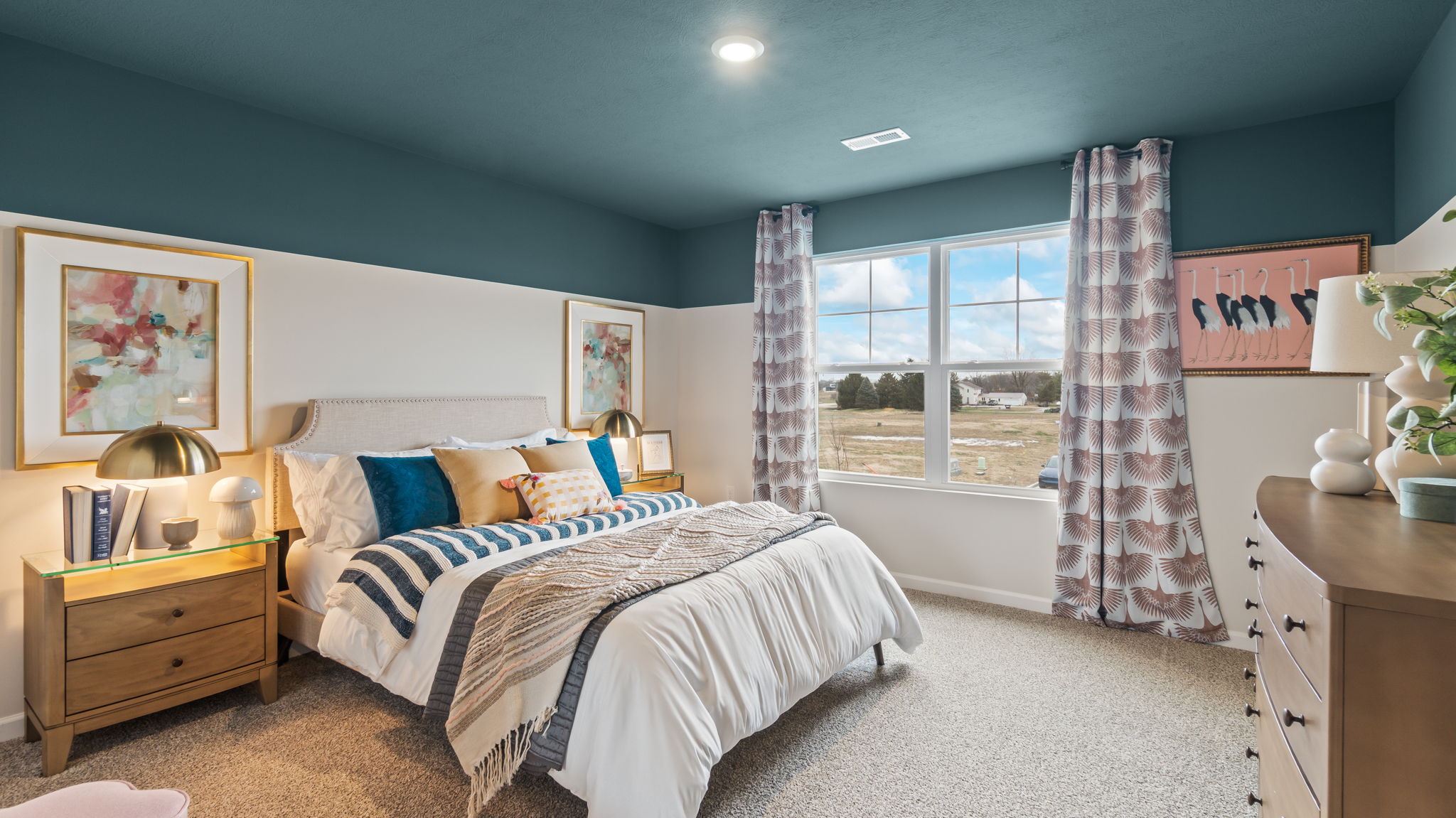 Bedroom 3 with Queen bed, blue and pink pastel color decorations, art, and paint.