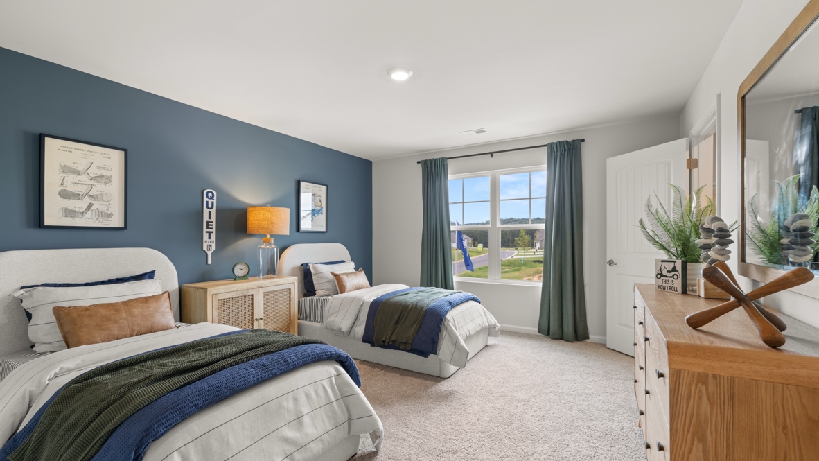 Bedroom 3 with two twin beds and brown dressers
