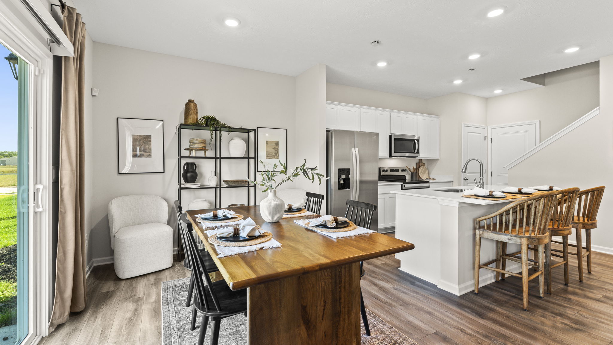 Quarter view of dining area with kitchen