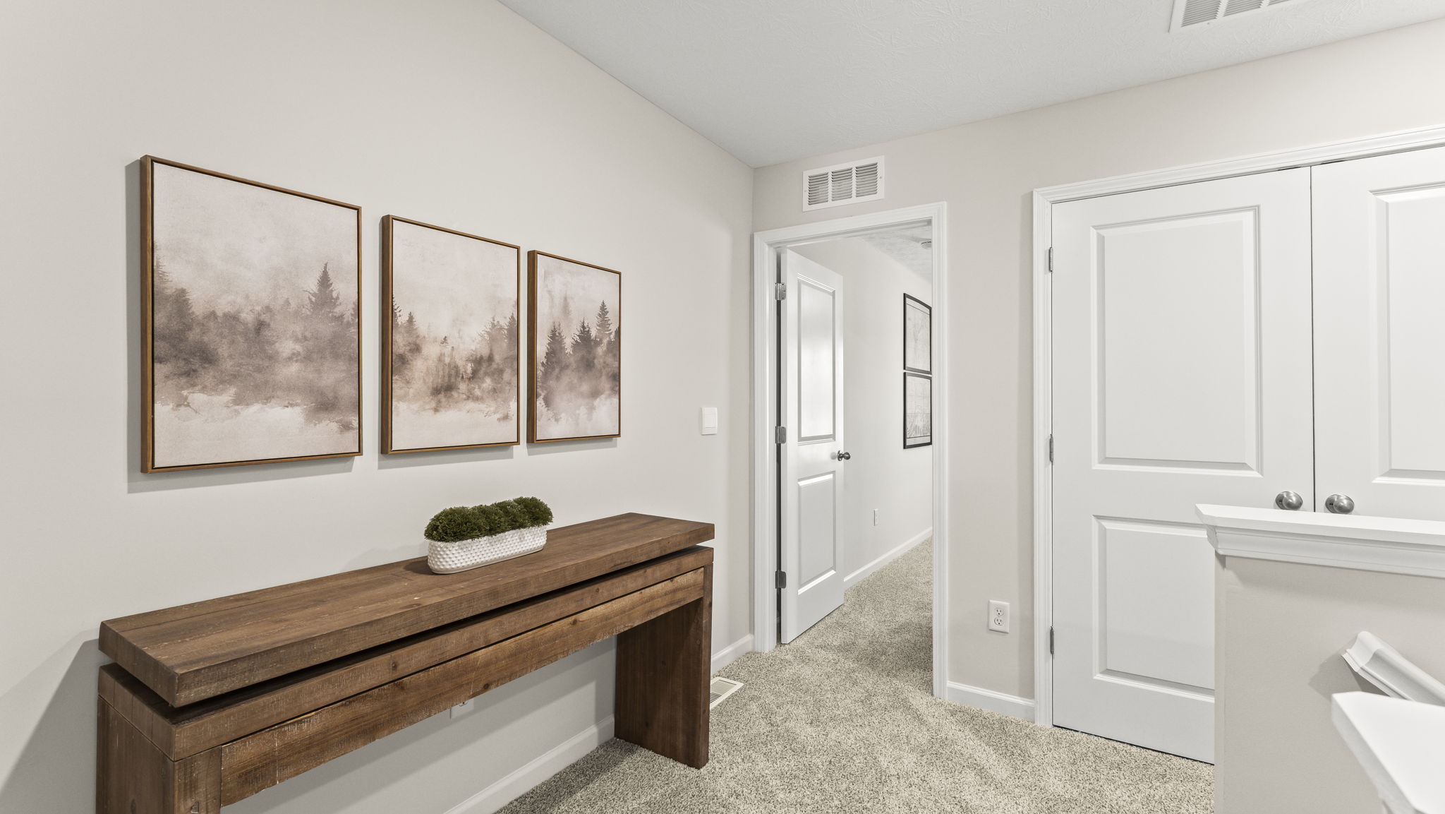 Upstairs hallway with table and artwork