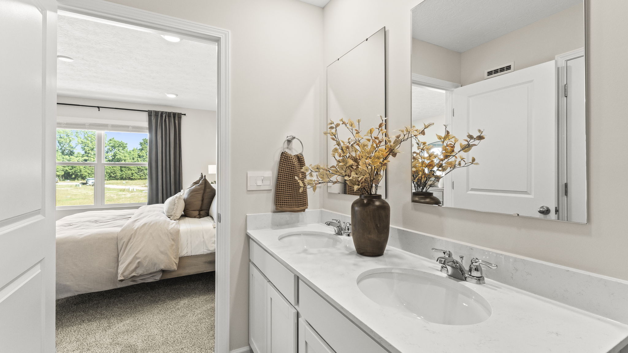Primary bathroom vanity with dual-sink and mirrors