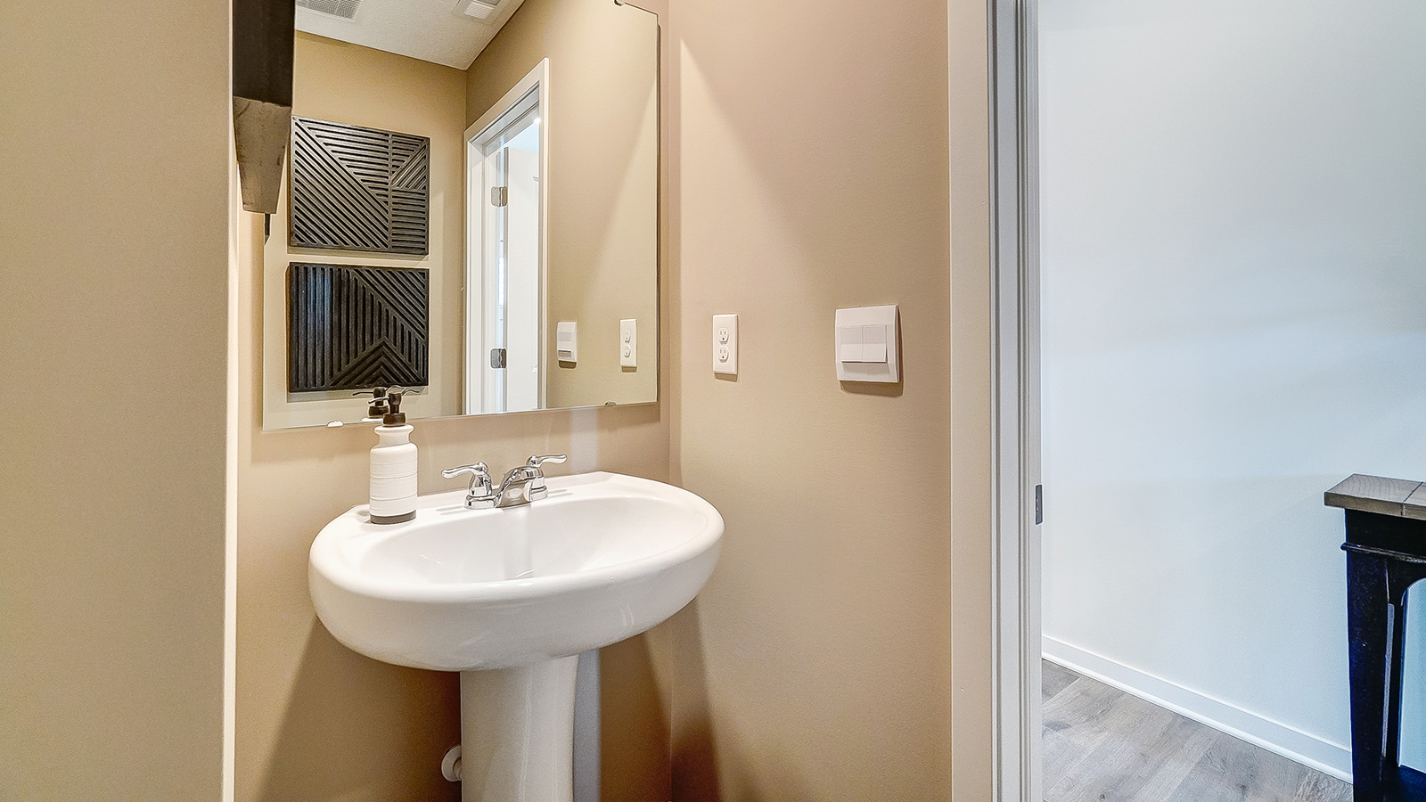 Powder room on the first floor with modern art.