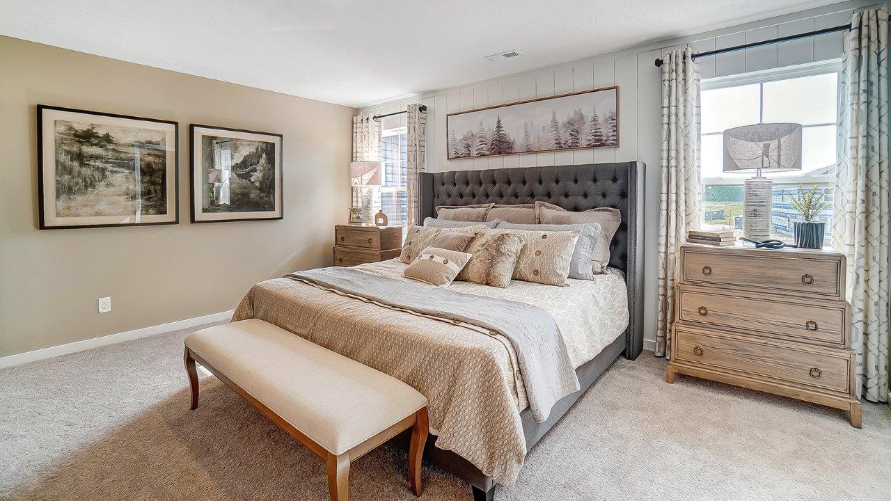Primary bedroom with wooden décor with large king bed.