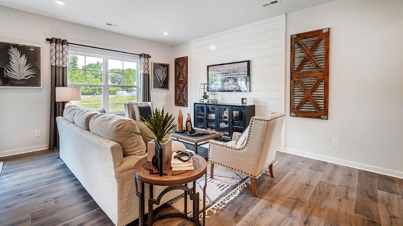 Living room in full with modern art and wooden décor.