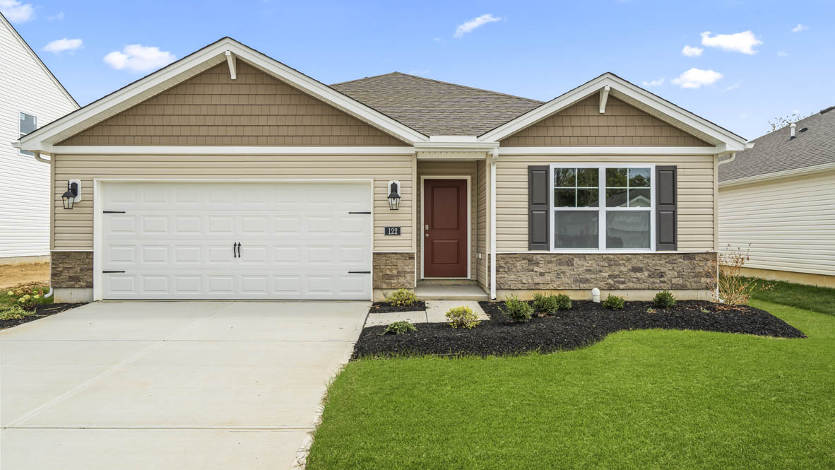 Bellamy plan home with grass, driveway, and garage.
