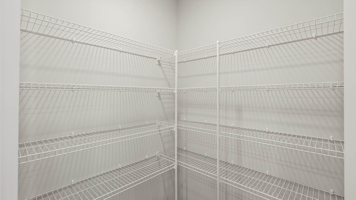 Walk-in pantry with wire rack shelving.