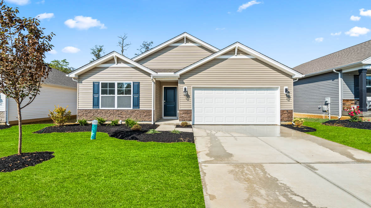 Newcastle home with green grass, neutral tone paint, and and turqoise window shutter