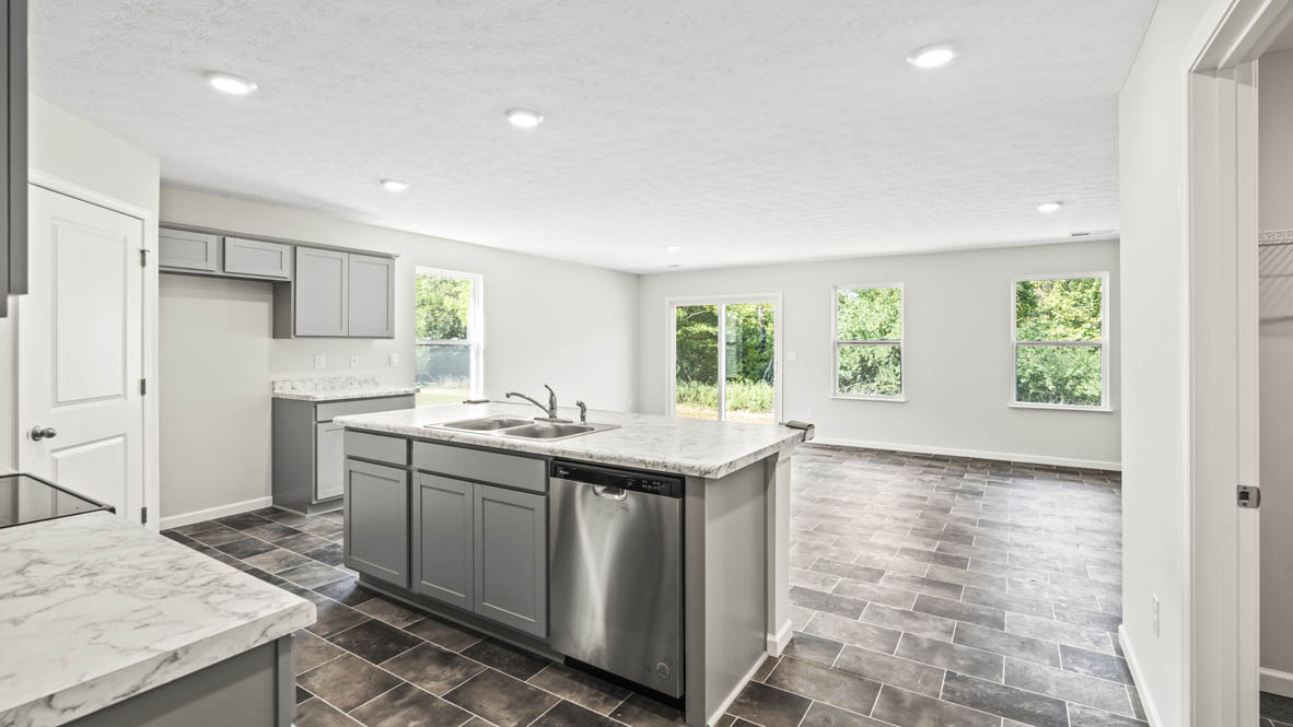 Kitchen from the perspective of the hallway looking at island with laminate countertop
