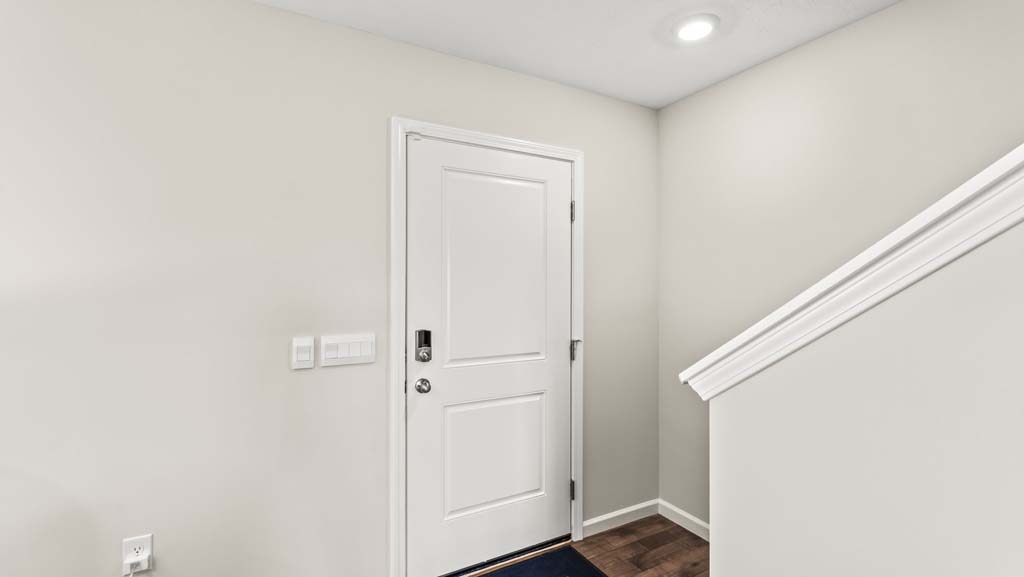 White front door with locks leading to upstairs
