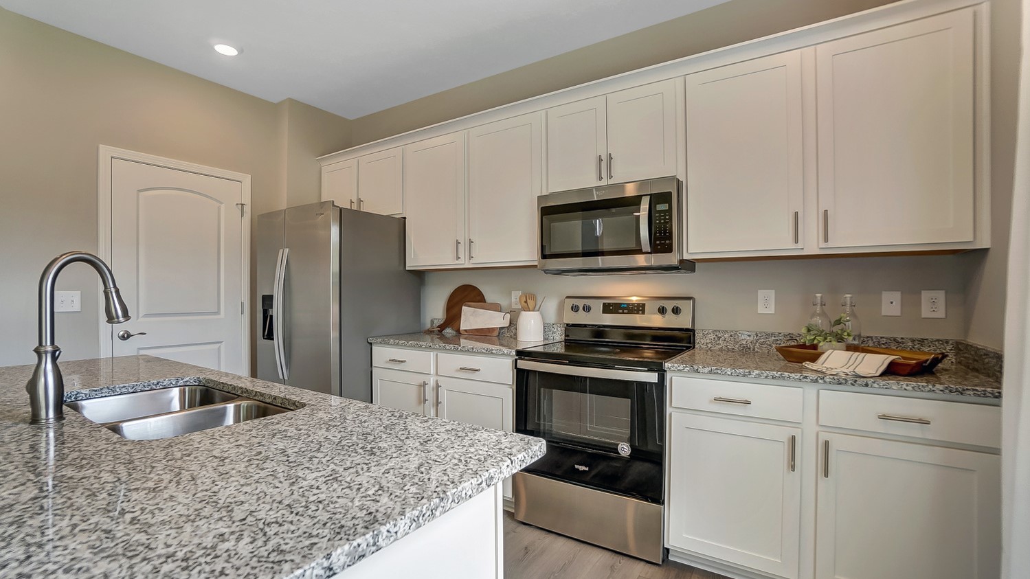 Close up on kitchen island and stainless steel appliances.