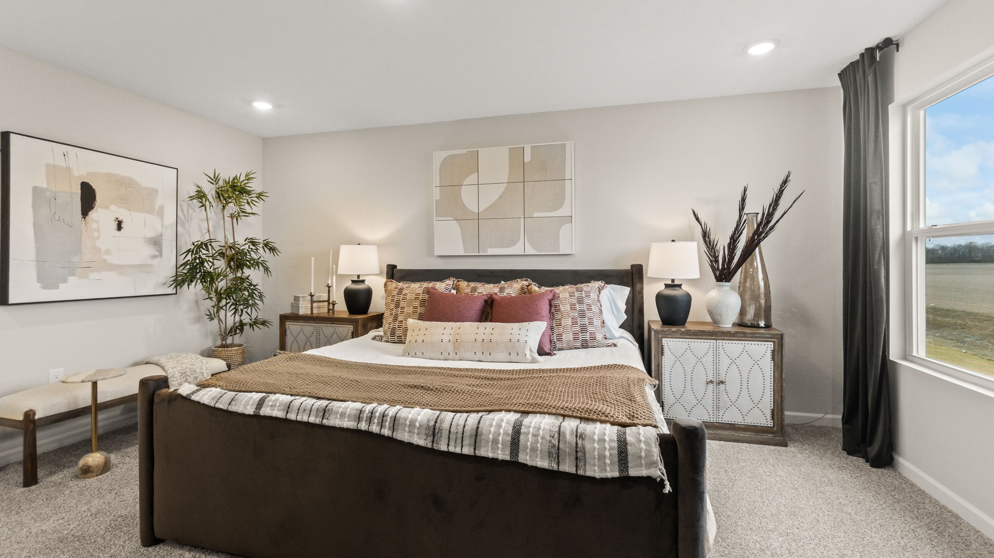 Closeup of primary bed below contemporary are on walls and nightstands on both sides.