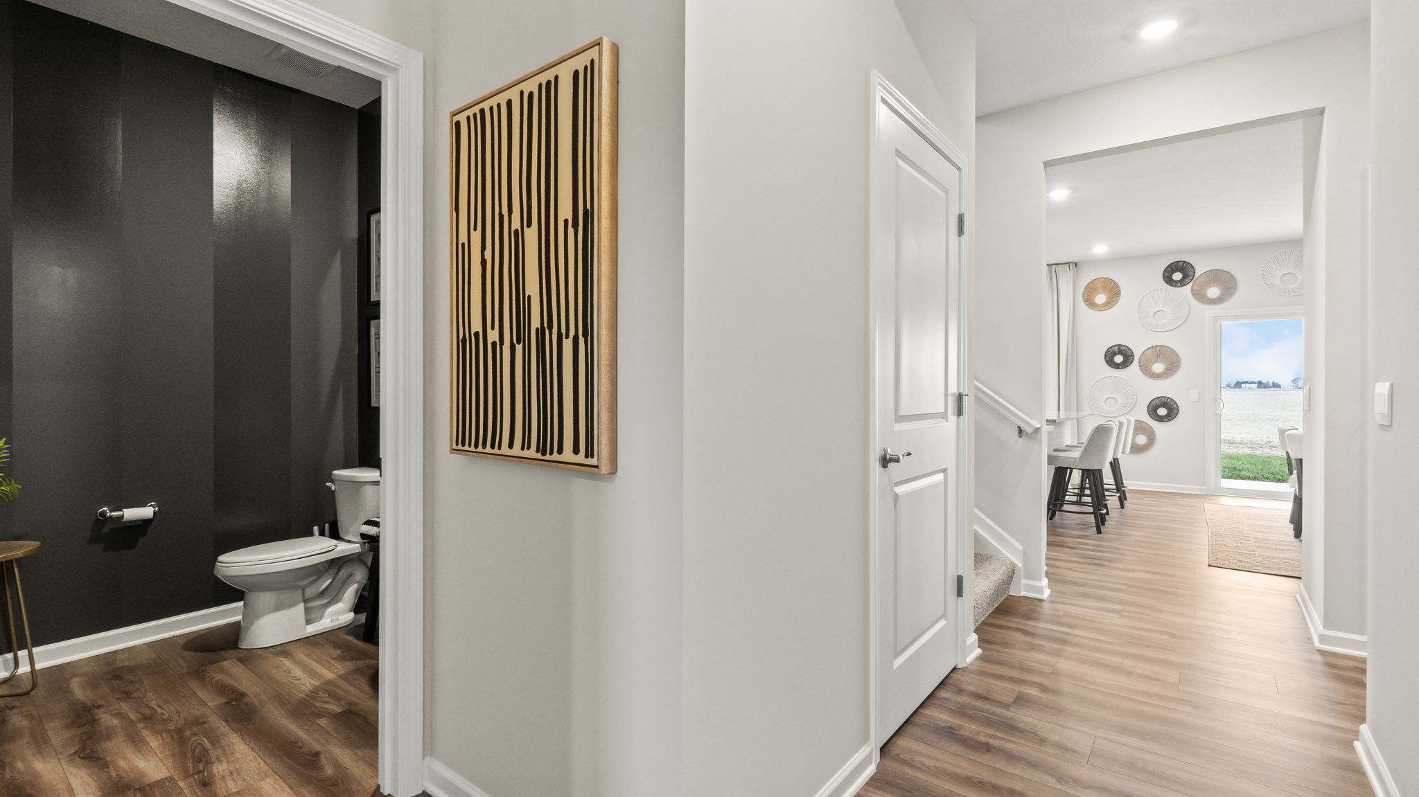 First floor hallway with door into powder room.