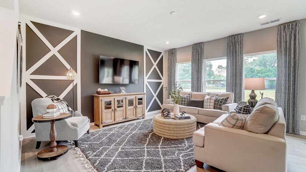 Living room with plush carpet and modern decorations.