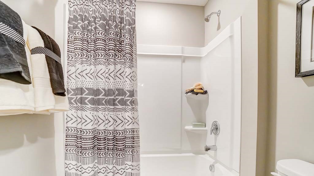 separate shower room in dual vanity shared bathroom.