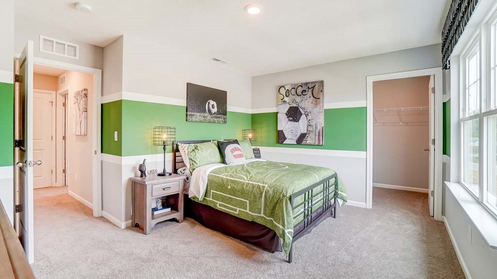 Bedroom with soccer theme and view into closet.
