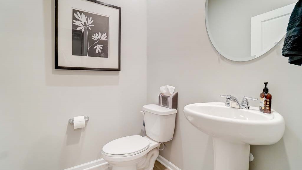 view of first floor powder room with toilet and bathroom.