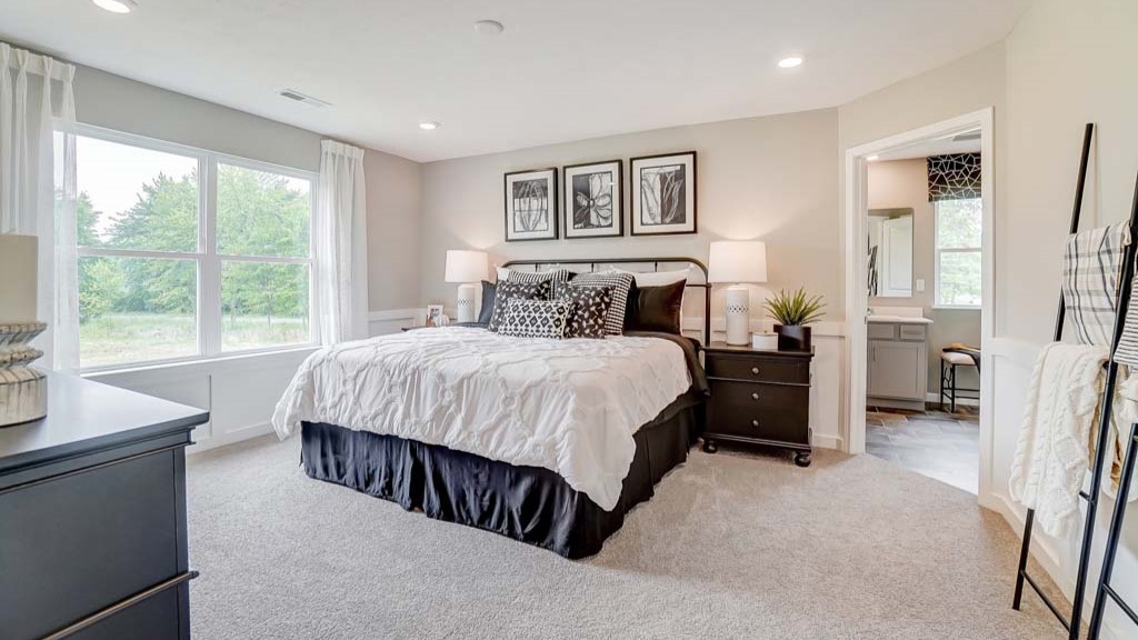 Primary Bedroom with a large bed, matching bedside tables, and modern decorations throughout.