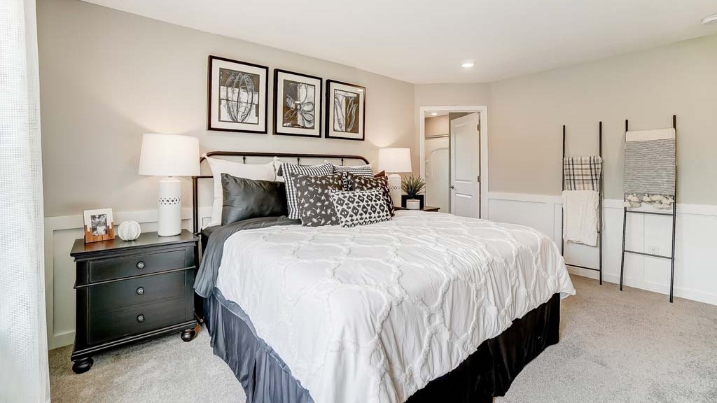 Primary Bedroom with corner view of bed with doorway into the private bathroom.