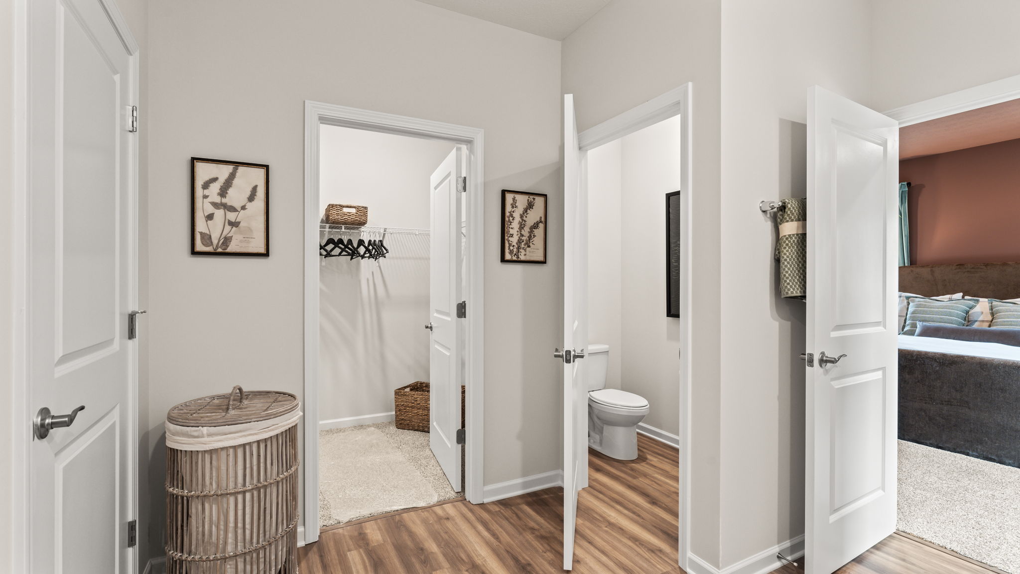Primary bathroom suite with doors to walk-in closet and toilet