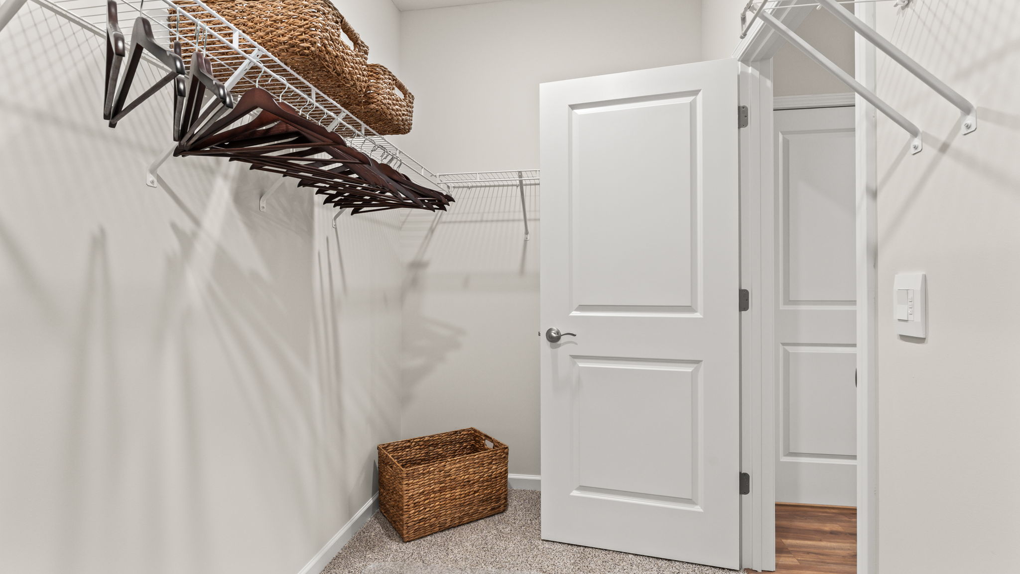 Walk-in closet with wire rack shelving,hangers, and basket