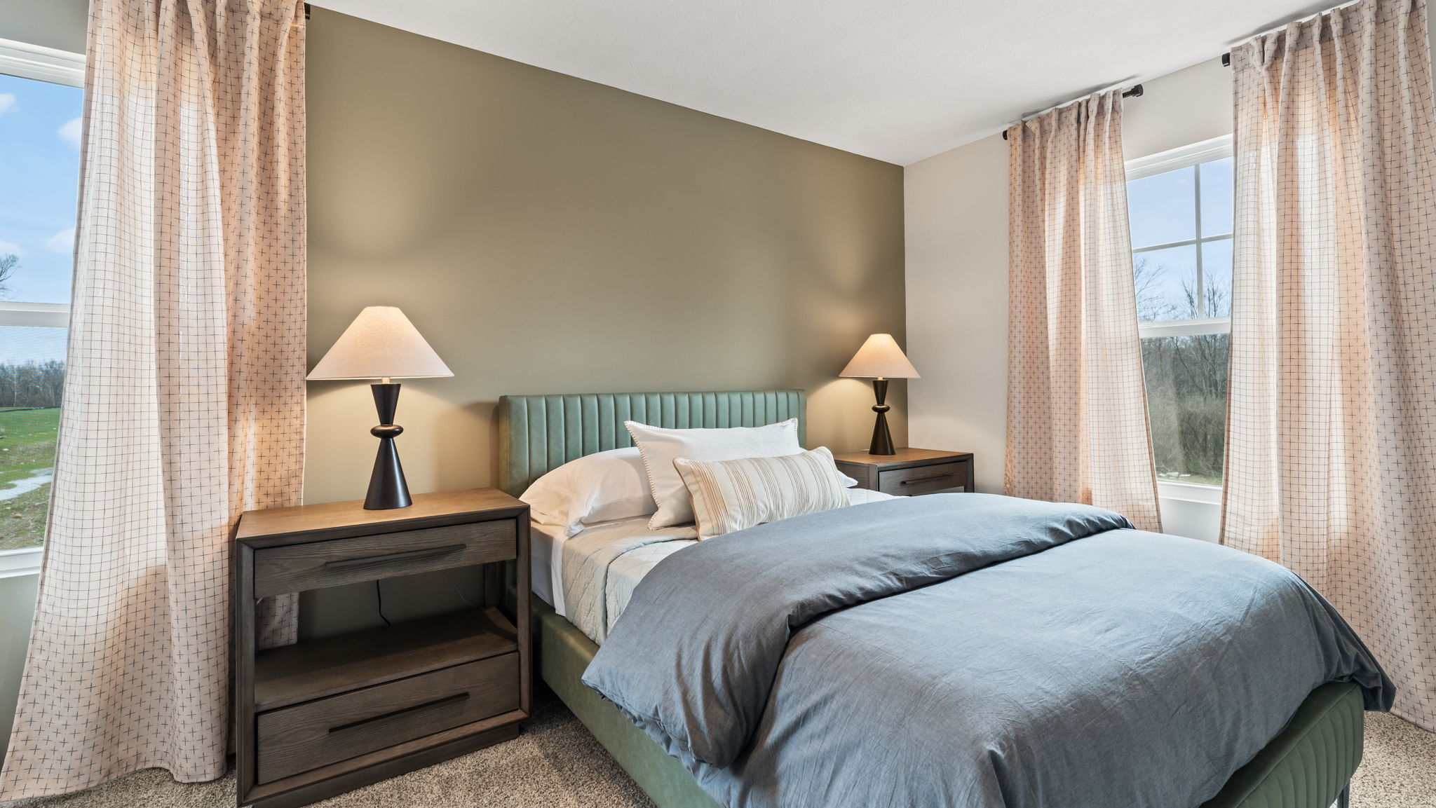 Closeup of neatly made bed with brown/white pillows and sheets